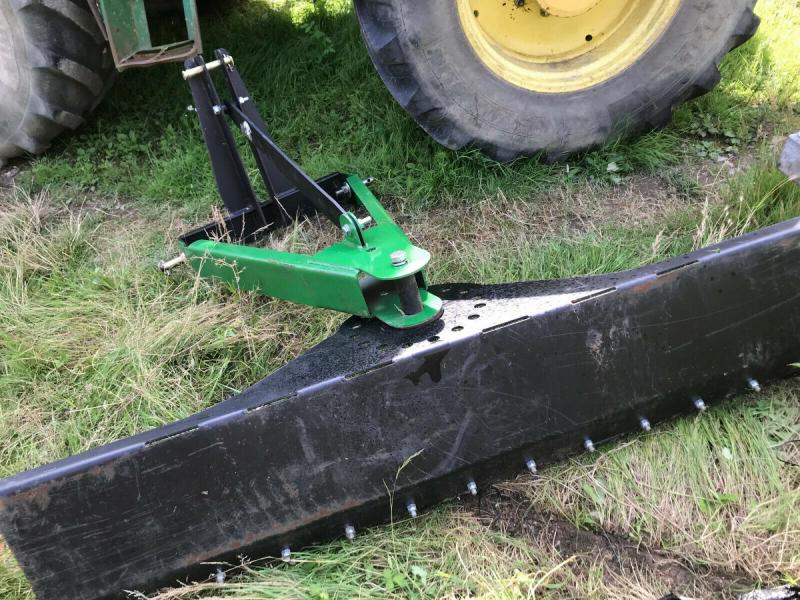 Tractor mounted scraper blade